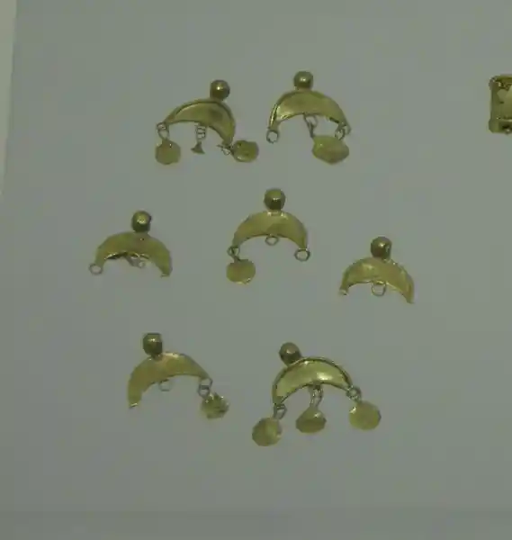 Crescent-shaped gold pendants with dangling circles